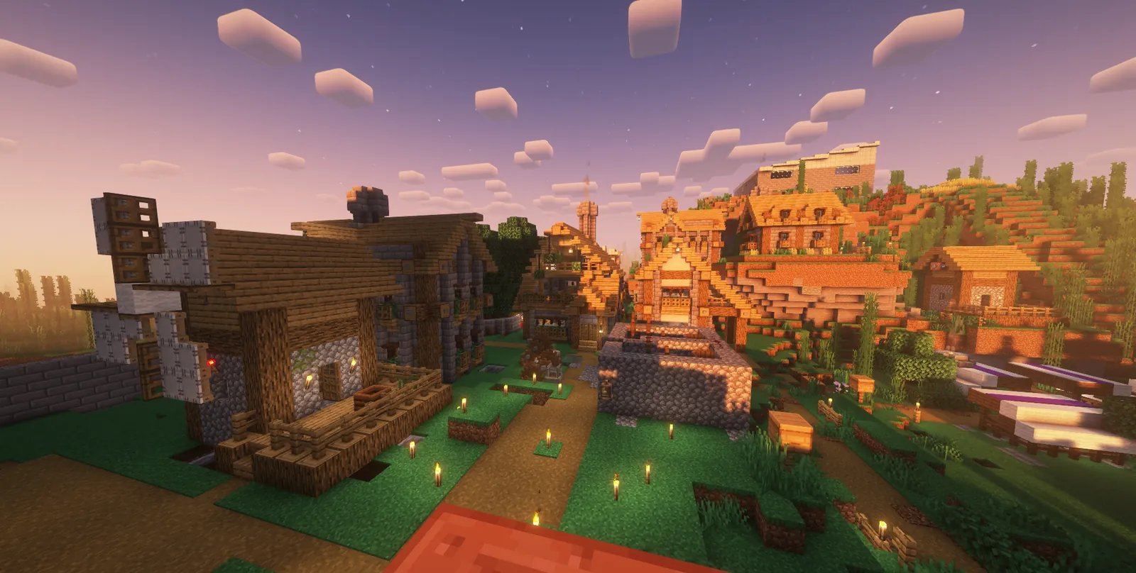 A village street with a well, timber houses and torches at sunset